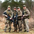 team of 4 hunters standing together with their rifles-1